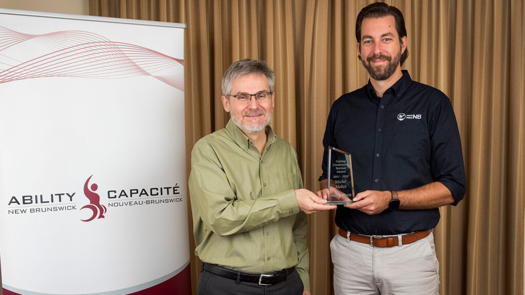 Mario Levesque, Ability NB Board Member presents Caring Community Partner Award to Michel Mallet.